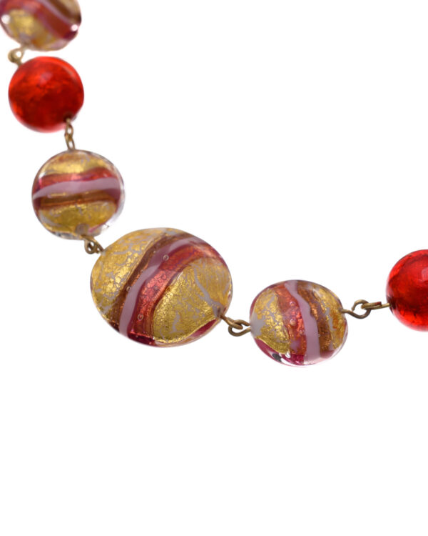 Close-up of a Murano necklace with vibrant red, pink, and gold beads